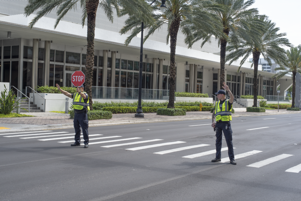 Safe 4 USA guards at crosswalk with stop signs and hi-vis vests